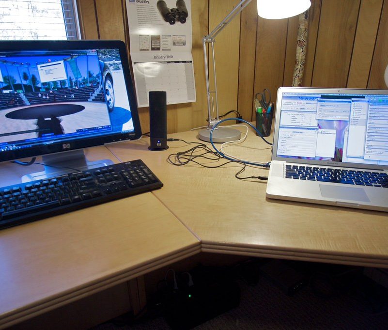 A work desk with a monitor and a laptop